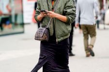 With dark purple fringe dress, olive green collarless bomber jacket and chain strap bag