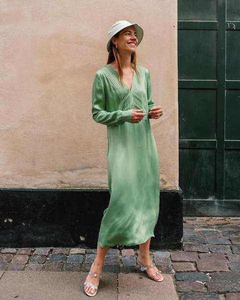 With green V-neck midi dress and embellished low heeled shoes