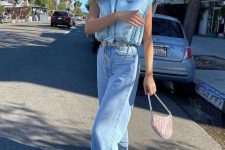 With light blue puffer vest, light blue loose jeans, pale pink bag, silver belt and shoes