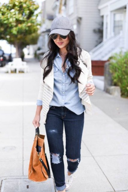 With light blue shirt, white and gray striped cardigan, distressed cuffed jeans, brown tote bag and white shoes