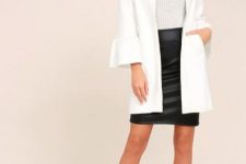 With light gray fitted sweater, black leather mini skirt, oversized sunglasses and embellished ankle strap high heels