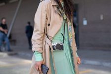 With mint green maxi dress and beige trench coat