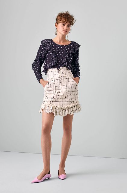 With navy blue and white polka dot ruffled blouse and lilac low heeled shoes