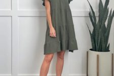 With olive green ruffled mini dress and gray lace up shoes