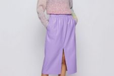 With pastel colored loose sweater and white lace up flat shoes