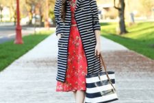 With red floral printed midi dress, golden belt, black and white striped tote bag and beige shoes