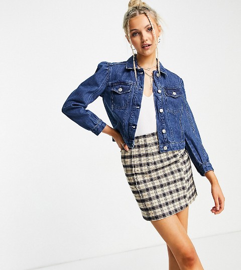 With white V-neck top, necklace and beige and black checked mini skirt