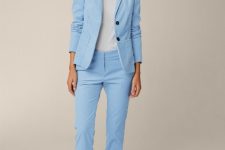 With white blouse, light blue trousers and white lace up flat shoes