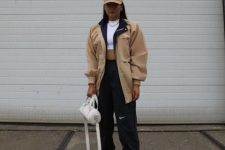 With white crop top, beige loose jacket, white bag, black jogger pants and white sneakers