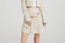 With white crop top, pastel colored tweed crop long sleeved collarless blazer and white leather mid calf heeled boots