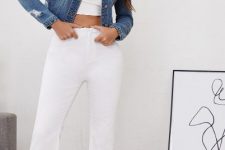 With white crop top, white flare trousers and high heels