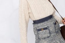 With white knitted long sleeved sweater and brown leather bag