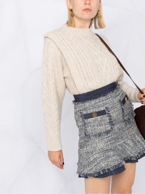With white knitted long sleeved sweater and brown leather bag