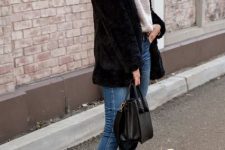 With white loose shirt, sunglasses, black faux fur jacket, black leather bag and skinny cropped jeans