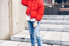 With white shirt, red puffer jacket and distressed jeans