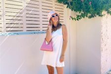 With white sleeveless mini dress, white framed sunglasses, pink bag and pink low heeled shoes
