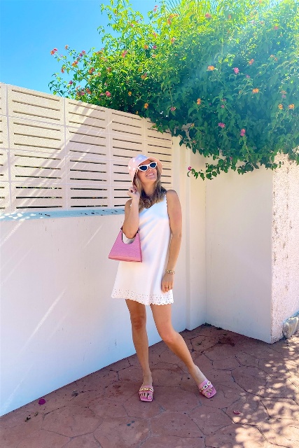 With white sleeveless mini dress, white framed sunglasses, pink bag and pink low heeled shoes
