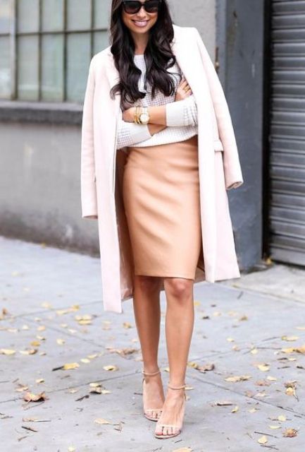 With white sweatshirt, pale pink midi coat, sunglasses and beige ankle strap high heels