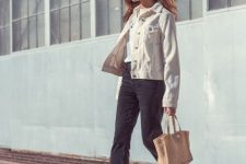 With white t-shirt, dark gray cropped jeans, beige tote bag and white lace up flat shoes