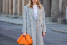 With white t-shirt, gray maxi coat, orange clutch and black long pants