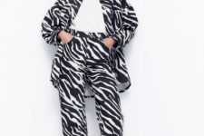 With white t-shirt, zebra printed long jacket and black shoes