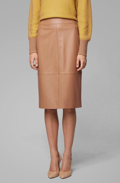 With yellow and light brown sweater and beige leather pumps