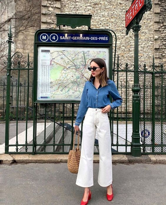 a Parisian-style look with a denim shirt, white flare jeans, red shoes and a woven bag is a lovely idea for French style lovers