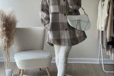 a comfy spring outfit with white leggings, white Chelsea boots, a checked shirt jacket, a white bag and a creamy hat