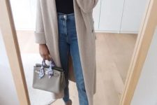 a cozy spring work look with a black tee, blue jeans, grey heels, a neutral long cardigan and a grey bag is amazing