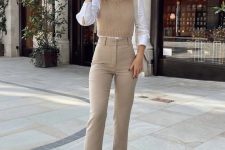 a preppy work look with a white shirt, a tan cropped waistcoat, tan high waisted jeans, bow shoes and a neutral bag