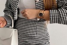 a pretty spring work outfit with a white ribbed turtleneck, a houndstooth print suit with a cropped blazer and a mini skirt, a white bag