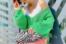 a white ribbed tank top, an apple green off the shoulder sweater, pink corduroy pants, a zebra print bag