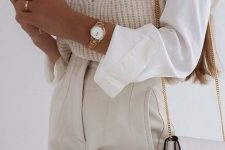 a white shirt, a woven waistcoat with ruffle sleeves, creamy high waisted pants, a grey bag and cool rings