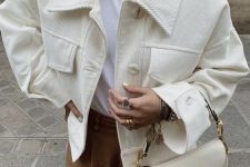 a white tee, brown suede trousers, a creamy corduroy cropped jacket, a creamy saddle bag