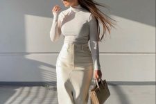 an elegant look with a white turtleneck, a creamy leather high waisted midi skirt with a slit, clear shoes and a tan bag