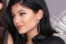 02 Kylie Jenner rocking 9 stacked helix piercings with matching hoop earrings and a statement long one