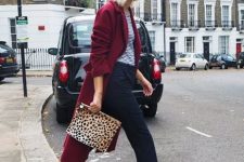 07 a striped t-shirt, navy cropped pants, hot red trainers, a burgundy trench and a leopard print clutch for a bold look