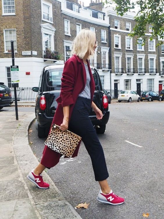 a striped t-shirt, navy cropped pants, hot red trainers, a burgundy trench and a leopard print clutch for a bold look
