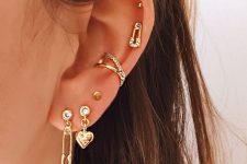 a lovely piercing idea with mismatched earrings