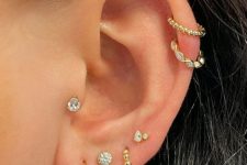 09 beautiful and glam ear styling with multiple lobe peircings, a tragus piercing and a double helix one, all done with gold hoops and studs