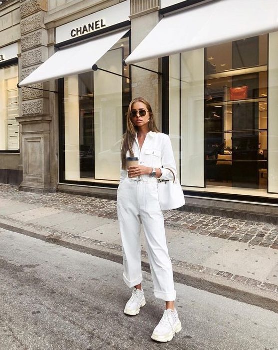 a white cargo jumpsuit, white dad trainers and a white bucket bag for a super elegant work look