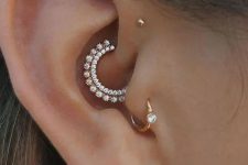 10 lovely ear styling with a lobe piercing with a hoop, a daith piercing, a tragus and a triple forward helix one with lovely and chic studs