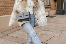 12 a white turtleneck, blue cropped jeans, white and blue trainers, a tan and white checked shaket, a dusty blue crossbody bag