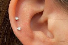 12 elegant minimalist ear styling with a double lobe piercing and a double helix ond with matching little stud earrings