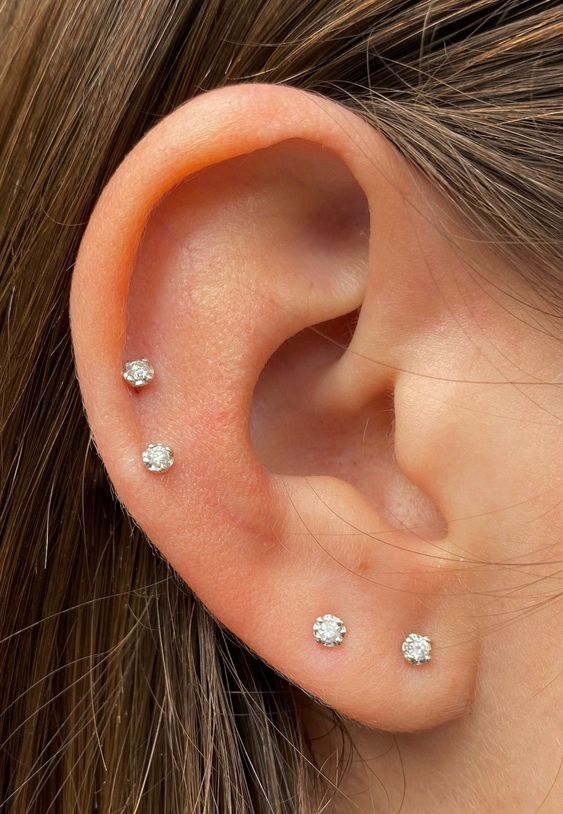 elegant minimalist ear styling with a double lobe piercing and a double helix ond with matching little stud earrings