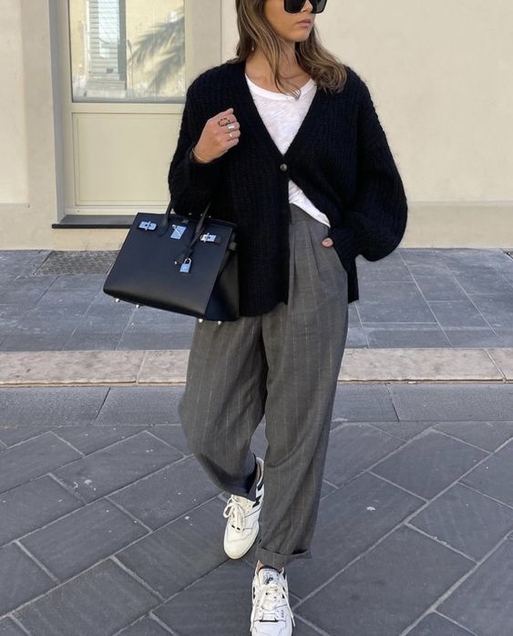 a white tee, a black cardigan, grey striped wideleg trousers, white trainers, a black tote for a chic look