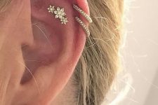 14 glam ear style with a large rhinestone stud in the lobe, with a beautiful flower stud in the flat and a double helix piercing with hoops