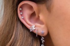 14 refined ear styling with a triple lobe peircing with beautiful floral earrings, a triple helix piercing with lovely studs