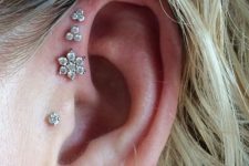 16 a tragus plus a triple forward piercing, all done with beautiful diamond studs look amazing and chic