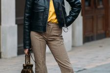 16 a yellow t-shirt, tan checked cropped trousers, tan trainers, a black leather jacket and a brown velvet bag for a bold look